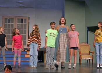 The actors playing the von Trapp children in "The Sound of Music" sing with their new governess Maria Rainer during a rehearsal of the musical on the Johnson Fine Arts Center stage at Northern State University. From left are Gretl, played by Kealey DesCamps); Marta, played by Ella Balgaard; Brigitta, played by Isabella Carlson; Kurt, played by Gabe Cogley; Maria, played by Hannah Gasperich; Louisa, played by Eden Barkmeier; and Liesl, played by Lexie Johnson. Missing is Friedrich, played by Haydler Schiferl. Courtesy photo.