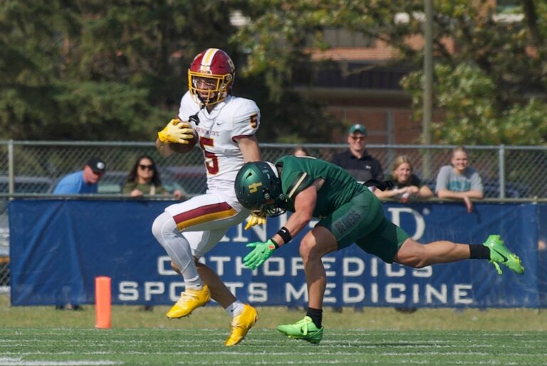Northern State's Carter Campbell tries to break the tackle of Bemidji State's Drayton Lehman during their game Saturday, Oct. 4 at Chet Anderson Stadium in Bemidji, Minn. The Beavers won 24-21. Photo by Cade Trenhaile for the Aberdeen Insider.