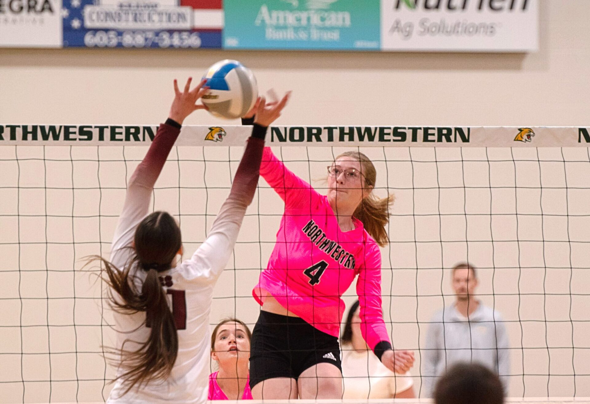 Northwestern's Ashley Haven hits through the block attempt by Aberdeen Christian's Ari Johnson Thursday, Oct. 7 in Mellette. Haven became the program's all-time leader in kills with 1,656, helping the Wildcats to a sweep. Aberdeen Insider photo by Allie Hoekman.
