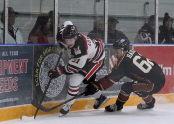 Aberdeen forward Easton Edwards battles Minot defenseman Jakub Habla for the puck during the first period Saturday, Oct. 11 at the Odde Ice Center. Edwards had two goals in the Wings 5-0 win. Aberdeen Insider photo by Allie Hoekman.