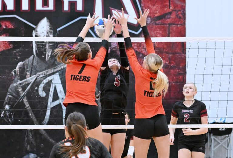 Aberdeen Christian's Sawyer Schwan battles Ipswich's Natalie Crissman, left, and Karlie Weisser for control of the ball at the net during the first set of their match Tuesday, Oct. 21 at the Aberdeen Christian Gym. Christian defeated Ipswich in four sets. Aberdeen Insider photo by Robb Garofalo.