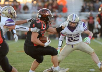 Ipswich's Casey Geditz tries to break the tackle of Harding County's Tyrel Koan, left, and get past Revyn Floyd during the first quarter of their 9A playoff game Thursday, Oct. 23 in Ipswich. Aberdeen Insider photo by Allie Hoekman.