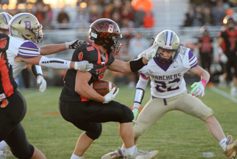 Ipswich's Casey Geditz tries to break the tackle of Harding County's Tyrel Koan, left, and get past Revyn Floyd during the first quarter of their 9A playoff game Thursday, Oct. 23 in Ipswich. Aberdeen Insider photo by Allie Hoekman.