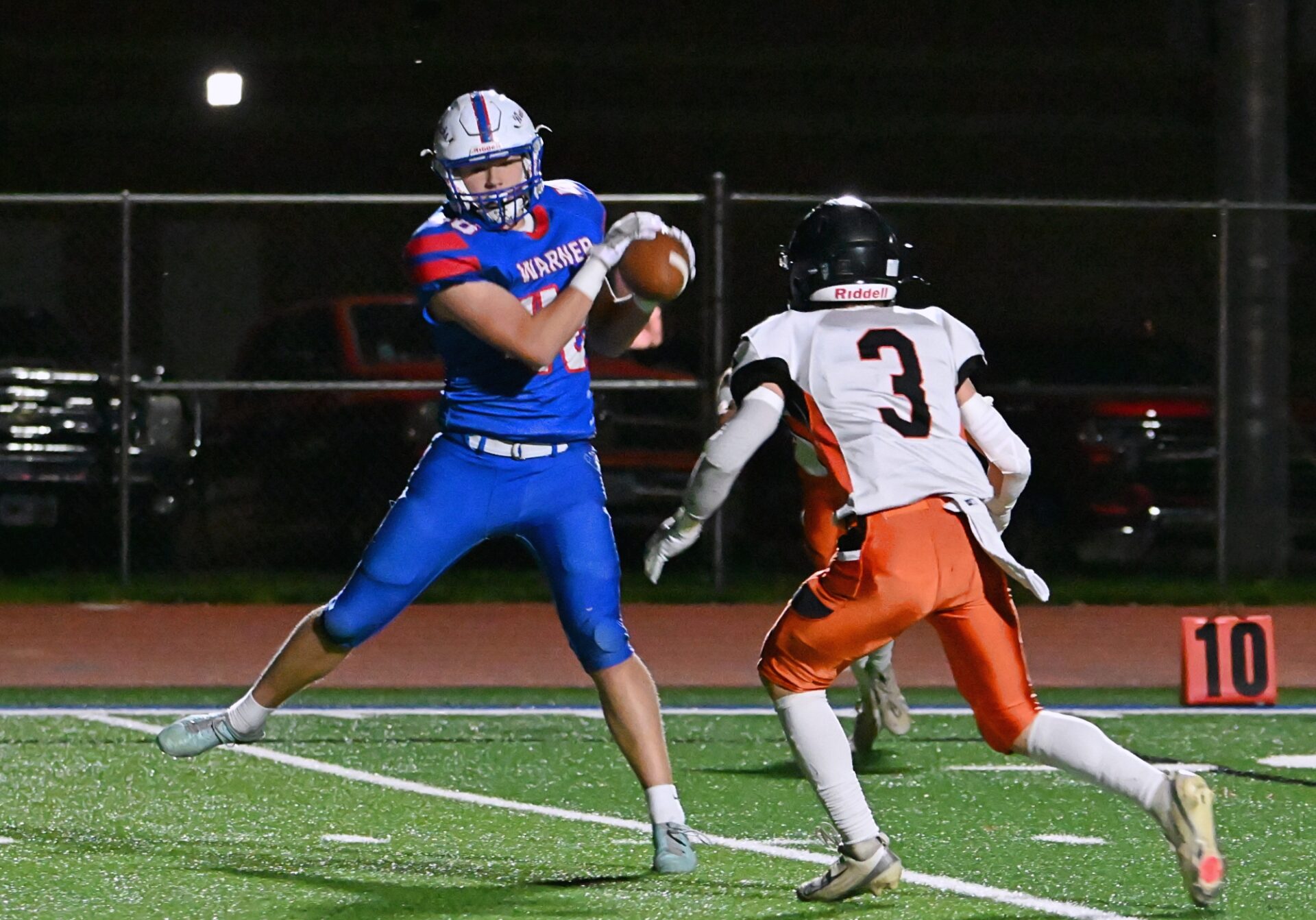 Warner's Alec Mikkelsen comes down with a catch in front of Howard's Kolt Becker during the first quarter of their Class 9A quarterfinal playoff game Thursday, Oct. 30 at BankNorth/Dial-A-Move Field in Warner. Mikkelsen scored on the play, but Howard won, 28-21. Aberdeen Insider photo by Robb Garofalo.