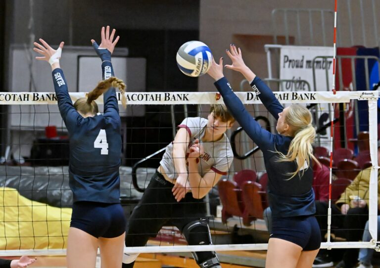 Northern State's Natalia Szybinska rips a spike through the block attempt by Concordia-St. Paul's Mehlayna Straub (4) and Audrey Waterman Saturday, Nov. 1 at Wachs Arena. The Wolves were swept by the ninth-ranked Golden Bears. Aberdeen Insider photo by Robb Garofalo.