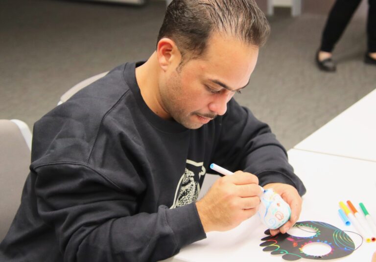 Carlos Camacho decorates a styrofoam skull, one of three activities at the K.O. Lee Aberdeen Public Library on Saturday, Nov. 1 for Dia de los Muertos, or Day of the Dead. Traditionally a sugar skull is decorated in honor of relatives who have died with designs specific to that person. Aberdeen Insider photo by Elisa Sand.