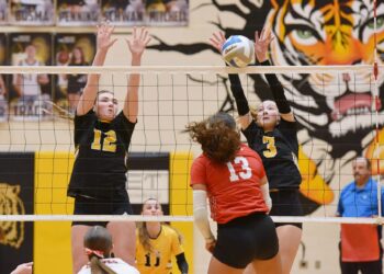 Britton-Hecla's Chellon Pruitt tries to hit through the block attempt of Groton's Rylee Dunker (12) and Tevan Hanson during their Region 1A Tournament match Thursday, Nov. 6 in Groton. The Tigers advanced to the Class A SoDak 16 with a four-set win. Aberdeen Insider photo by Robb Garofalo.