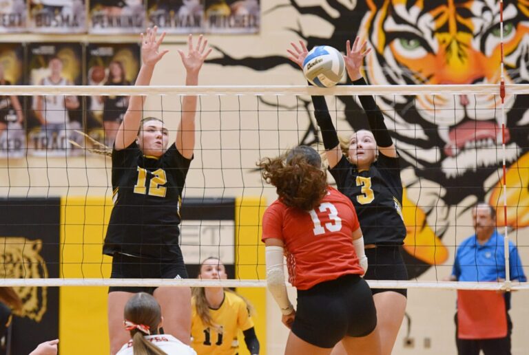 Britton-Hecla's Chellon Pruitt tries to hit through the block attempt of Groton's Rylee Dunker (12) and Tevan Hanson during their Region 1A Tournament match Thursday, Nov. 6 in Groton. The Tigers advanced to the Class A SoDak 16 with a four-set win. Aberdeen Insider photo by Robb Garofalo.