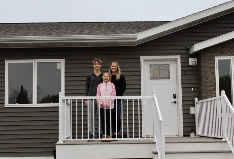 The 14th house built by Hub Area Habitat for Humanity was sold to Gavin, Krystina and, in front, Addilyn Hauck. It was finished in late October. Courtesy photo.