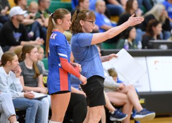 Warner head coach Kari Jung talks with Courtney Leidhlot before rotating her in during a match against Aberdeen Roncalli earlier this season. Jung guided the Monarchs to their 17th trip to the Class B state tournament, which begins Thursday, Nov. 20 in Rapid City. Aberdeen Insider photo by Robb Garofalo.