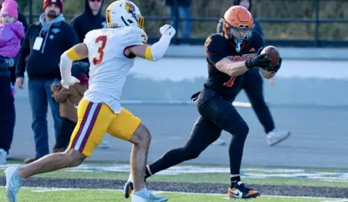 Jamestown's Ethan Hoffman reaches for the goal line as Northern State defender Ewald Andrew closes in during the Wolves' 46-40 victory on Saturday, Nov. 15 in Jamestown, N.D. Photo courtesy of Jamestown University Athletics.