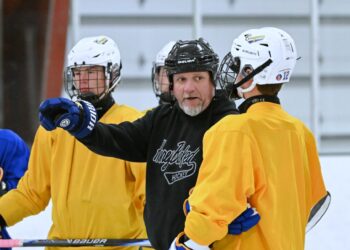 Aberdeen Cougar head boys coach Dana Myhre talks with Carter Vilhauer during practice Monday, Nov. 17 in the Hollum Expo Building. Myhre makes his coaching debut Friday, Nov. 21 against Dickinson, N.D., inside the Odde Ice Center. Aberdeen Insider photo by Robb Garofalo.