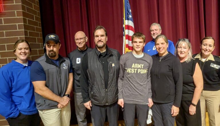 Central High School senior Esten Foss, center, learned Tuesday, Nov. 25 that he has been accepted to the U.S. Military Academy at West Point. He was joined on stage by his family, school personnel and others. Photo courtesy of Aberdeen Public Schools.