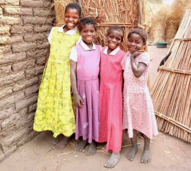 Four Malawi girls wearing dresses they received from Mommy Missions. Courtesy photo.