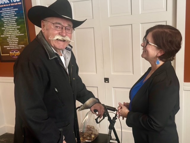 Nikki Gronli, the Democratic candidate running for the U.S. House of Representatives, follows up with Larry Stroschein on agriculture issues after speaking at the Brown County Democratic luncheon. Aberdeen Insider photo by Shannon Marvel.