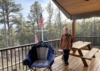 Custer County resident Lea Anne McWhorter stands on the patio of her home. Since buying it in 2018, she and her husband have seen their property taxes increase over 22%. South Dakota News Watch photo by Kevin Killough.