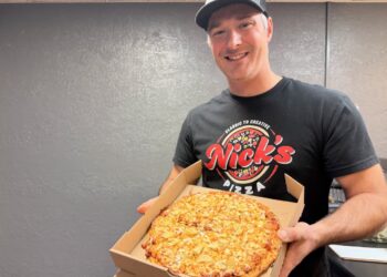 Nick Schaunaman holds a fresh semi-loaded sloppy joe pizza from Nick's Pizza. He recently rebranded his business, which had previously been called Jimmy's Pizza. Aberdeen Insider photo by Elisa Sand.