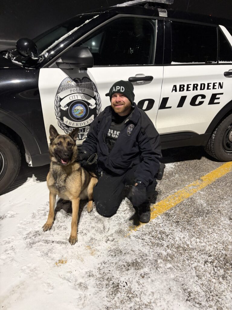 Officer Clayton Innis poses by his new partner Denny, the Aberdeen Police Department's latest drug dog. Courtesy photo.