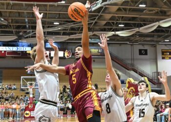Northern State's Nelson Reynolds drives to the basket between Southwest Minnesota's Aeron Stevens, left, and Brayson Boike during the first half Saturday, Jan. 31 at Wachs Arena. Reynolds had 12 points, helping the Wolves cap off I Hate Winter weekend with a 70-63 win. Aberdeen Insider photo by Robb Garofalo.