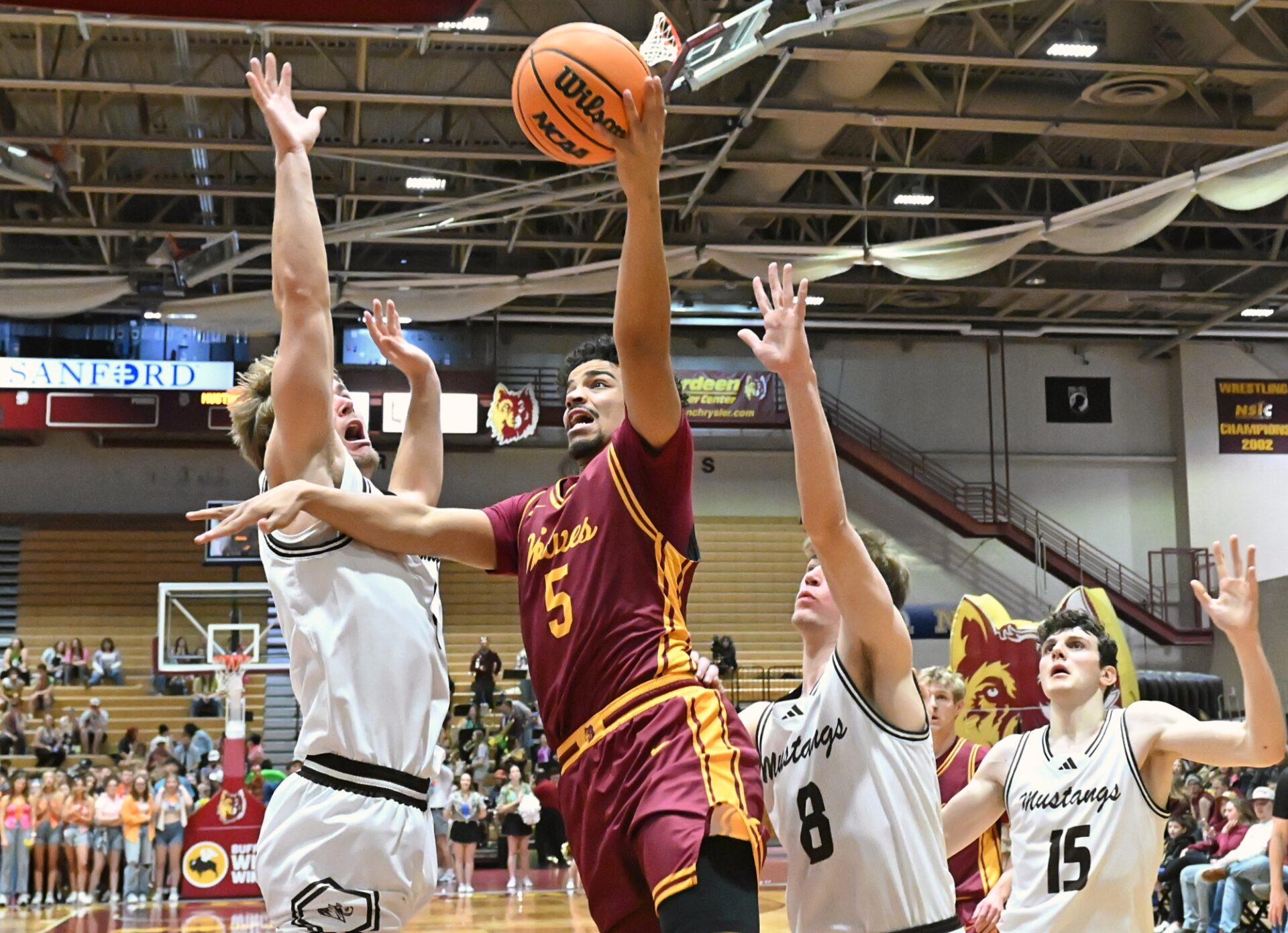 Northern State's Nelson Reynolds drives to the basket between Southwest Minnesota's Aeron Stevens, left, and Brayson Boike during the first half Saturday, Jan. 31 at Wachs Arena. Reynolds had 12 points, helping the Wolves cap off I Hate Winter weekend with a 70-63 win. Aberdeen Insider photo by Robb Garofalo.