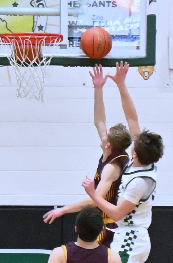 Webster Area's Seth Lesnar drives and scores on Aberdeen Roncalli's Quinten Shelton during the fourth quarter Friday, Jan. 2 inside Roncalli Gym. Lesnar had 18 points in a 55-52 Webster win. Aberdeen Insider photo by Robb Garofalo.