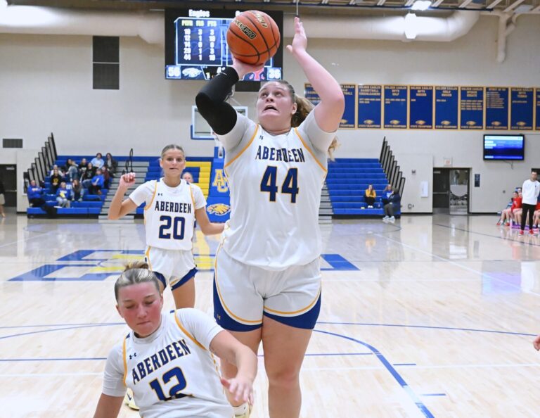 Aberdeen Central's Taryn Hermansen manages to avoid falling teammate Kennadi Withers in the lane and scores on an offensive rebound and put-back against Yankton Saturday, Jan. 3 inside Golden Eagles Arena. Hermansen had a game-high 25 points in a 76-51 Central win. Aberdeen Insider photo by Robb Garofalo.