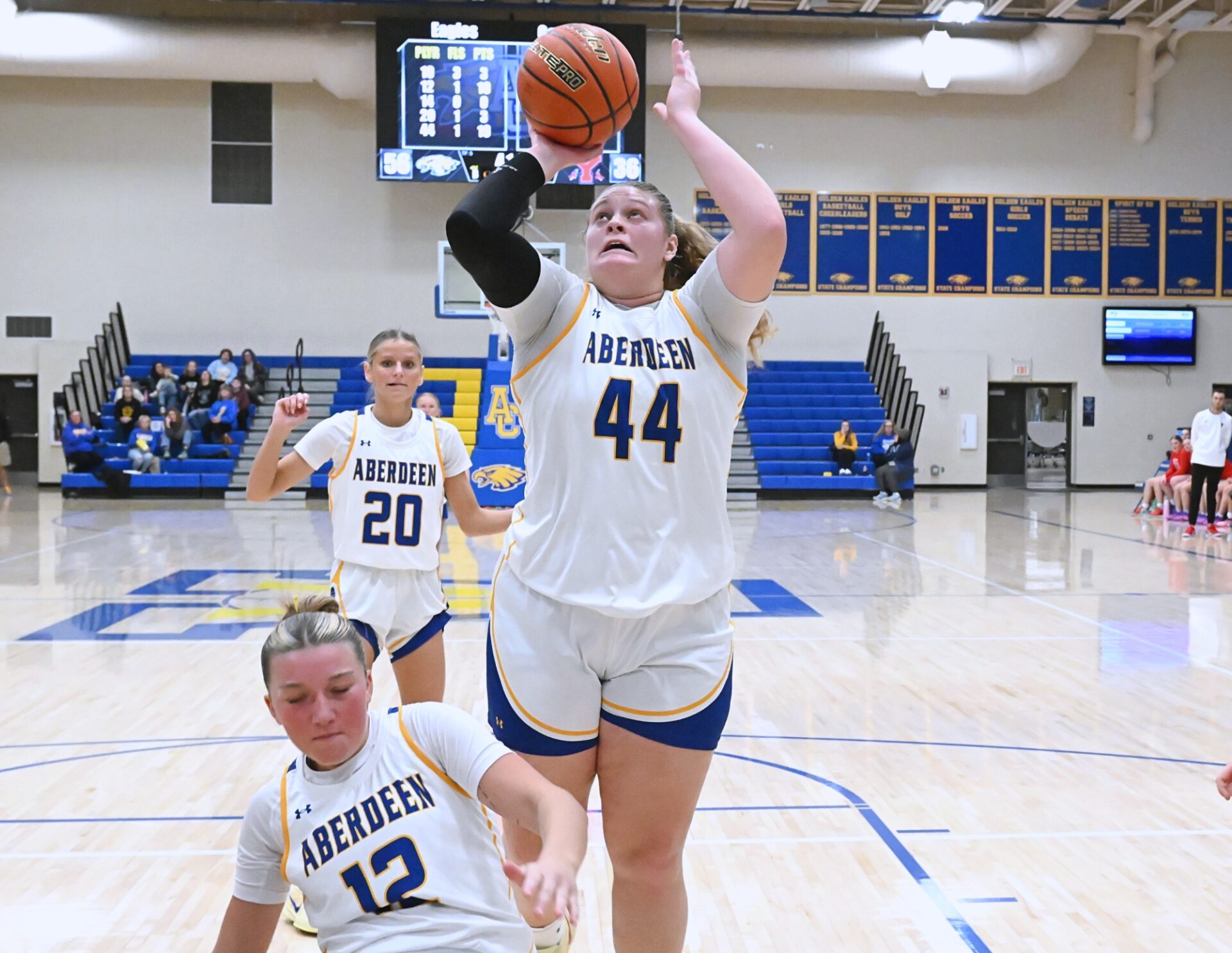Aberdeen Central's Taryn Hermansen manages to avoid falling teammate Kennadi Withers in the lane and scores on an offensive rebound and put-back against Yankton Saturday, Jan. 3 inside Golden Eagles Arena. Hermansen had a game-high 25 points in a 76-51 Central win. Aberdeen Insider photo by Robb Garofalo.