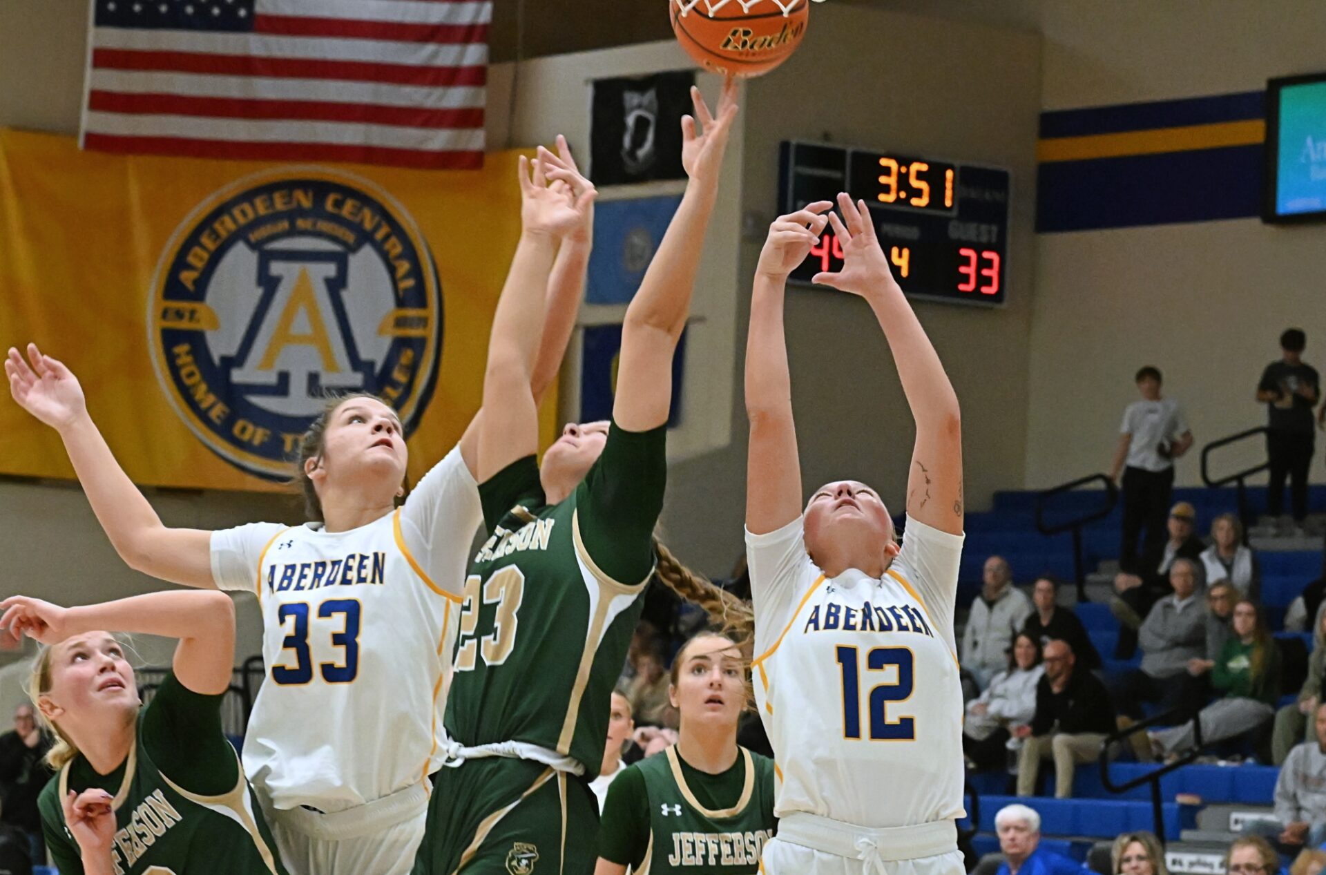Aberdeen Central's Kennadi Withers, right, and Lauryn Burckhard battle Sioux Falls Jefferson's Brinley Altenburg for a rebound during the third quarter Saturday, Jan. 10 at Golden Eagles Arena. Withers came away with the board, helping Central log a 60-38 victory. Aberdeen Insider photo by Robb Garofalo.