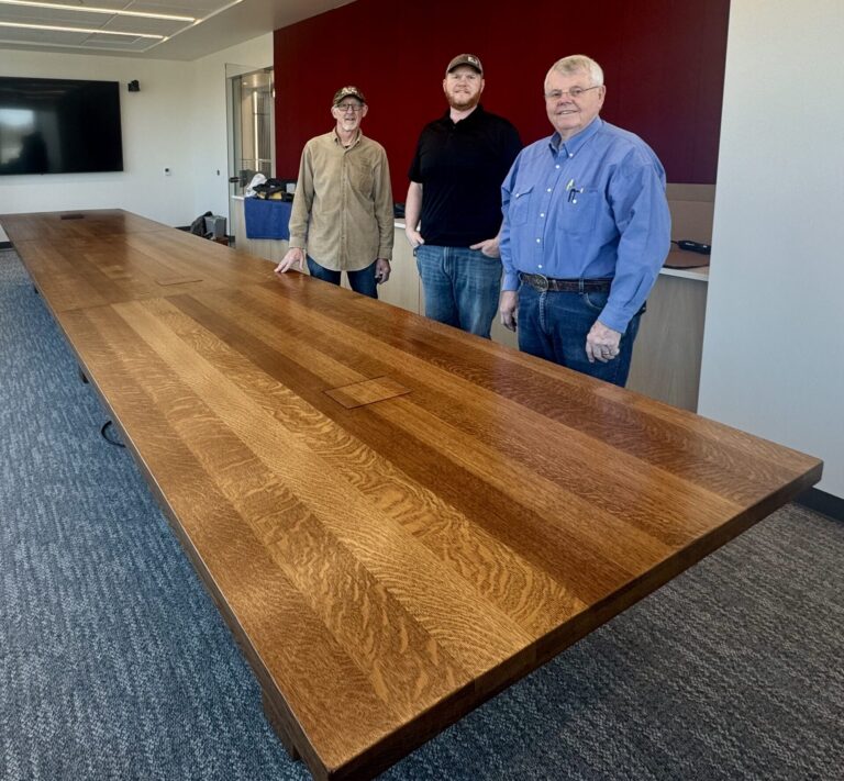 Doug Grote, Jim McHugh and Mike McHugh built a conference room table for Northern State's new Business and Innovation Center. They used wooden boards salvaged from Lincoln Hall. Aberdeen Insider photo by Shannon Marvel.