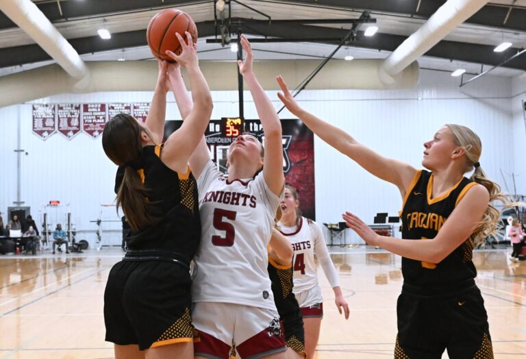 Aberdeen Christian's Arianna Johnson, center goes up for a rebound against Faulkton's Khloe Kaup, left, and Claire Cotton during the Trojans' 50-23 win Tuesday, Jan 20 at the Aberdeen Christian Gym. Aberdeen Insider photo by Robb Garofalo.