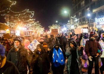 Hundreds gather around a growing memorial site at 26th Street and Nicollet Avenue South in Minneapolis, where federal agents shot and killed Alex Pretti Saturday, Jan. 24 earlier in the day. Minnesota Reformer photo by Nicole Neri.