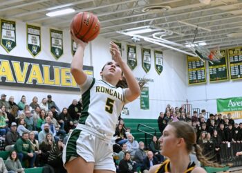 Aberdeen Roncalli's Gabby Thomas drives to the hoop past Groton Area's Taryn Traphagen during the first quarter of their game Tuesday, Jan. 27 at the Roncalli Gym. Thomas scored 13 points in a 43-31 Roncalli win. Aberdeen Insider photo by Robb Garofalo.