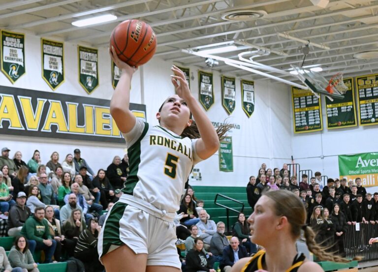 Aberdeen Roncalli's Gabby Thomas drives to the hoop past Groton Area's Taryn Traphagen during the first quarter of their game Tuesday, Jan. 27 at the Roncalli Gym. Thomas scored 13 points in a 43-31 Roncalli win. Aberdeen Insider photo by Robb Garofalo.