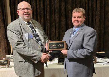 Jeff Wolff, left, receives the Pork All American Award at the South Dakota Pork Producers Council from council president Jason Foster. Courtesy photo.