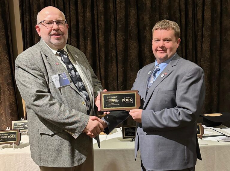 Jeff Wolff, left, receives the Pork All American Award at the South Dakota Pork Producers Council from council president Jason Foster. Courtesy photo.
