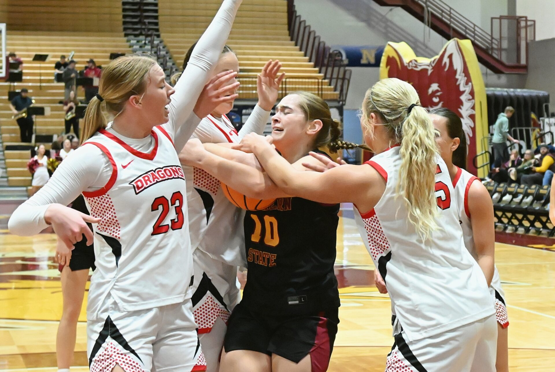 Northern State's Lily Klein battles, from left, MSU Moorhead's Abby Berge, Terryn Johnson and Caylin Kelly for a rebound during the first quarter of the Wolves' 61-41 win Saturday, Feb. 7 inside Wachs Arena. Klein grabbed the ball and drew a foul on Kelly. Aberdeen Insider photo by Robb Garofalo.