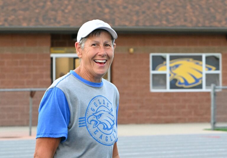 Aberdeen Central Athletic Director Dawn Seiler takes a moment to smile for the camera during the Al Sahli Invitational track meet Friday, May 9, 2025, at the Brownell Activities Complex at Aberdeen Central High School. Seiler is retiring at the end of the 2025-26 school year. Aberdeen Insider photo by Robb Garofalo.