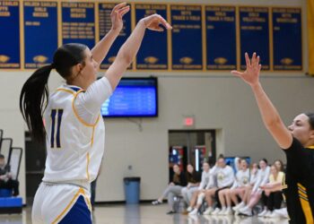Aberdeen Central's Kamdyn Borge follows through on a three-pointer that broke a 43-43 tie in the fourth quarter against Mitchell Tuesday, Feb. 10 at Golden Eagles Arena. Borge had 11 points in a 57-52 win. Aberdeen Insider photo by Robb Garofalo.
