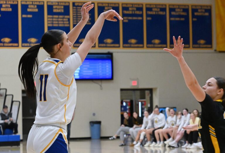 Aberdeen Central's Kamdyn Borge follows through on a three-pointer that broke a 43-43 tie in the fourth quarter against Mitchell Tuesday, Feb. 10 at Golden Eagles Arena. Borge had 11 points in a 57-52 win. Aberdeen Insider photo by Robb Garofalo.