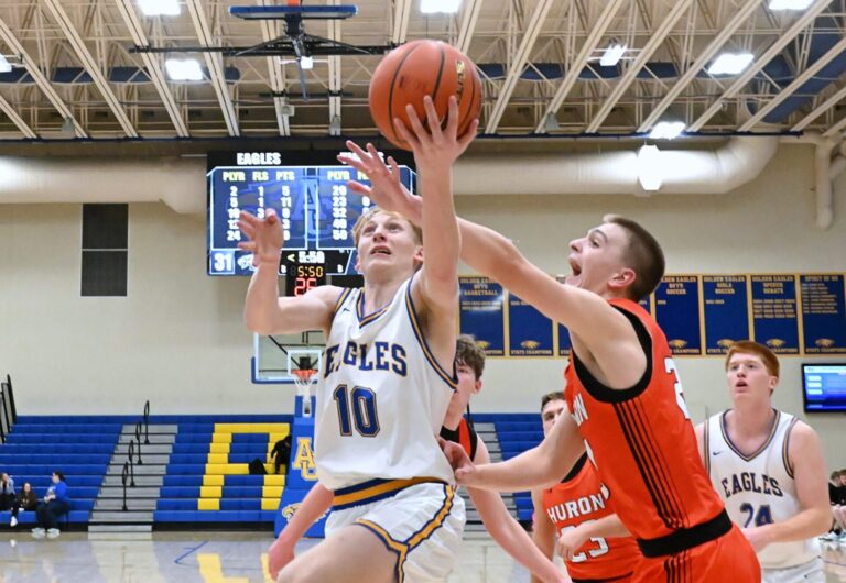 Aberdeen Central's Bryson Burgard drive to the rim in front of Huron's Myles Ellwein during the fourth quarter of their game Thursday, Feb. 12 at Golden Eagles Arena. Huron won 64-40. Aberdeen Insider photo by Robb Garofalo.