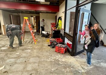 Redfield Area Development Corp. director Gianna Schieffer checks on the progress of work at the Spink County Daycare being built in Redfield. With her is her daughter Maya. South Dakota News Watch photo by Bart Phankuch.