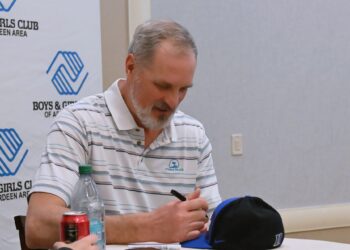 Christian Laettner signs a Duke Blue Devils hat before the start of the Boys & Girls Club of Aberdeen Area's annual banquet Friday, Feb. 13 at the Dakota Events Center. Laettner was this year's keynote speaker. Aberdeen Insider photo by Robb Garofalo.