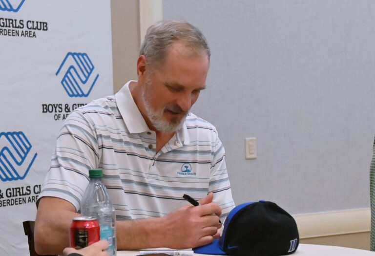 Christian Laettner signs a Duke Blue Devils hat before the start of the Boys & Girls Club of Aberdeen Area's annual banquet Friday, Feb. 13 at the Dakota Events Center. Laettner was this year's keynote speaker. Aberdeen Insider photo by Robb Garofalo.