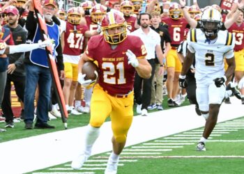 Northern State running back Hank Kraft outruns Concordia-St. Paul's Hudson Jean to the end zone during a 2025 game at Dacotah Bank Stadium. Kraft and the Wolves open the 2026 season at home on Aug. 27 against Chadron State. Aberdeen Insider file photo by Robb Garofalo.