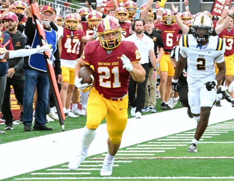 Northern State running back Hank Kraft outruns Concordia-St. Paul's Hudson Jean to the end zone during a 2025 game at Dacotah Bank Stadium. Kraft and the Wolves open the 2026 season at home on Aug. 27 against Chadron State. Aberdeen Insider file photo by Robb Garofalo.