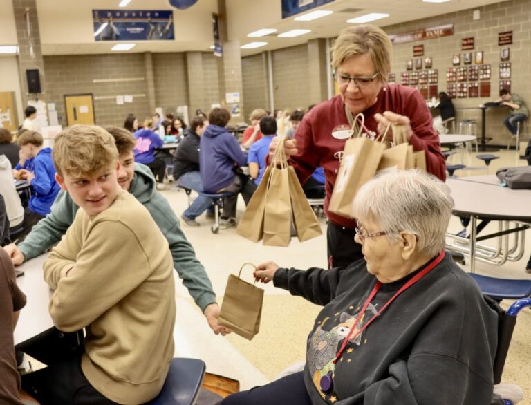 Primrose resident Louise Hoffman hands gift bags to Central High School students Drake Soderlund, left, and Jackson Post on Random Acts of Kindness Day, which was Tuesday, Feb. 17. Photo courtesy of Aberdeen Public Schools.