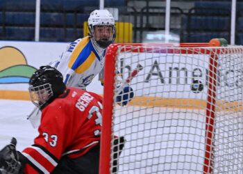 Aberdeen forward Paxton Dallman watches the puck go into the net after his shot goes over Huron goaltender Jace Gerber's shoulder during the third period of the Cougars' 9-1 win Sunday, Feb. 22 in the Odde Ice Center. Aberdeen Insider photo by Robb Garofalo.