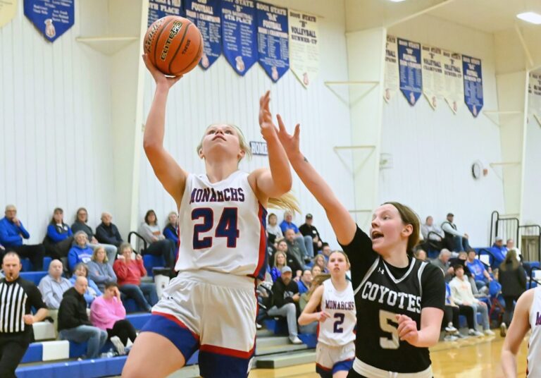 Warner's McKenna Leidholt scores off a steal in front of Waubay/Summit's Jolene Kranz during the fourth quarter of their Region 1B Tournament game Tuesday, Feb. 24 in Warner. Leidholt had 13 points to lead the Monarchs to a 45-22 victory. Aberdeen Insider photo by Robb Garofalo.