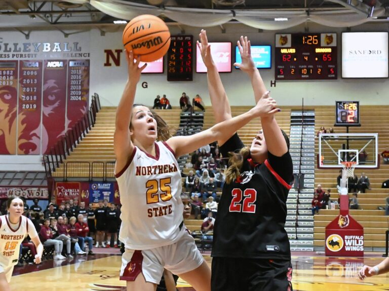 Northern State's Izzy Moore drives to the rim past Minnesota State Moorhead's Terryn Johnson during the fourth quarter of their Northern Sun Intercollegiate Conference Tournament game Wednesday, Feb. 25 at Wachs Arena. Moore scored 19 points, but the Wolves lost 68-67 in overtime. Aberdeen Insider photo by Robb Garofalo.