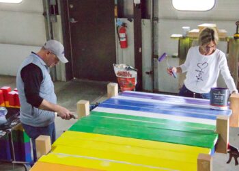City cemetery manager Ryan Smith and Barb Grosz paint parts of a rainbow bridge that will eventually be placed in the new pet burial area at Riverside Memorial Cemetery. Aberdeen Insider photo by Elisa Sand.